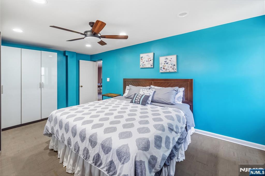 682 Floyd Street Englewood Cliffs, NJ 07632 - Photo 23 of 33 a bedroom with a large bed and a chandelier
