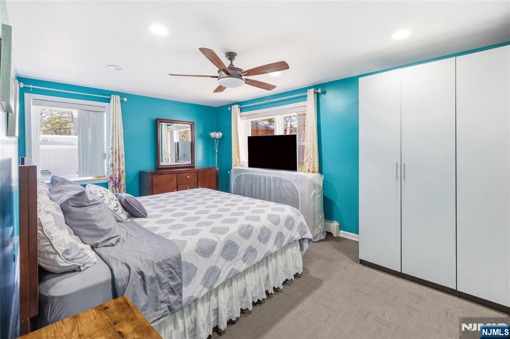 682 Floyd Street Englewood Cliffs, NJ 07632 - Photo 24 of 33 a bedroom with a large bed and a chandelier
