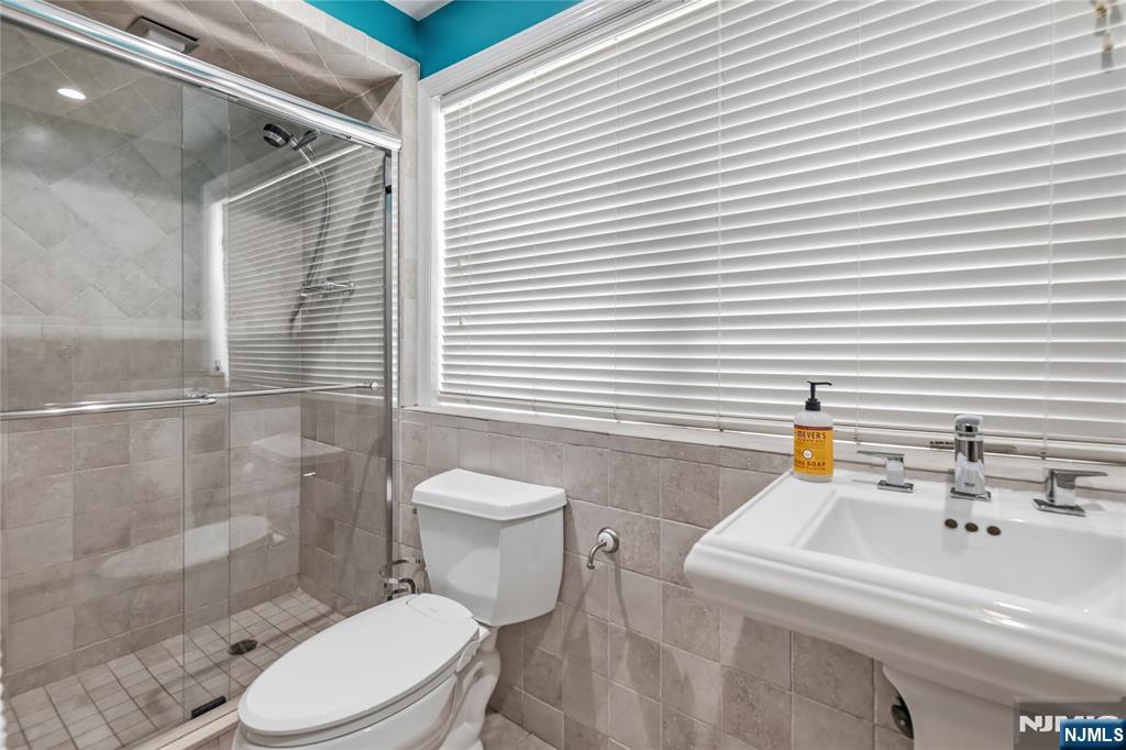 682 Floyd Street Englewood Cliffs, NJ 07632 - Photo 28 of 33 a bathroom with a sink a toilet and shower