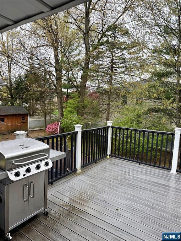 682 Floyd Street Englewood Cliffs, NJ 07632 - Photo 32 of 33 a balcony with wooden floor table and chairs