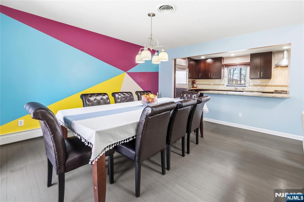 682 Floyd Street Englewood Cliffs, NJ 07632 - Photo 10 of 33 a view of a dining room with furniture and chandelier