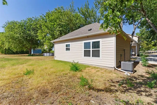 a backyard of a house with table and chairs