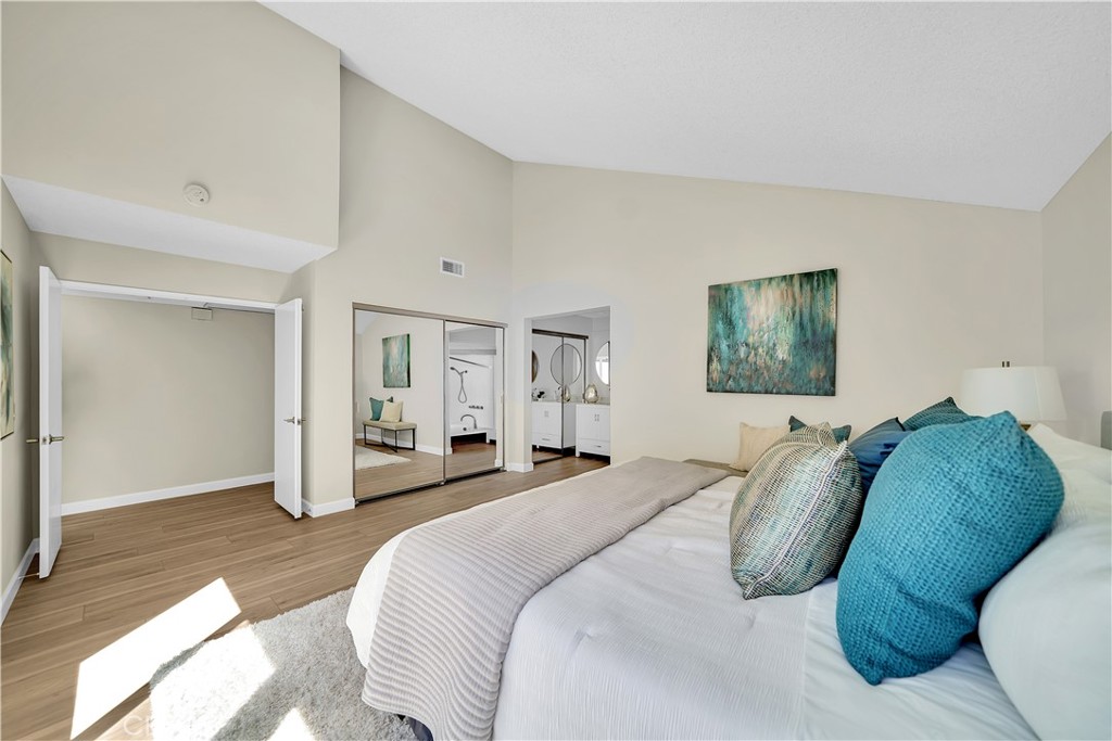 13 Willowbrook Irvine, CA 92604 - Photo 16 of 34 a spacious bedroom with a bed and a couch