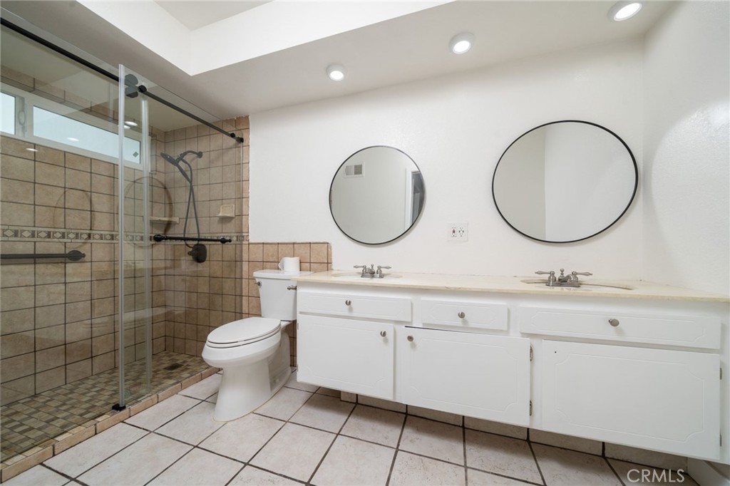 1153 Flintlock Road Diamond Bar, CA 91765 - Photo 6 of 16 a bathroom with a double vanity sink mirror and toilet