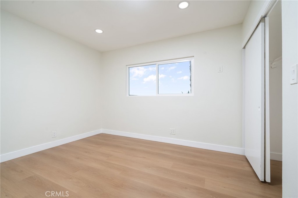 1153 Flintlock Road Diamond Bar, CA 91765 - Photo 10 of 16 an empty room with wooden floor and windows