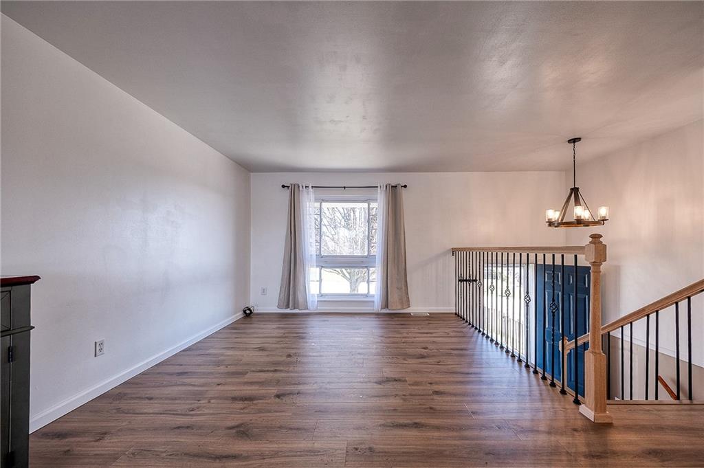 9871 Deerfield Drive Irwin, PA 15642 - Photo 11 of 35 a view of an empty room with wooden floor and a window