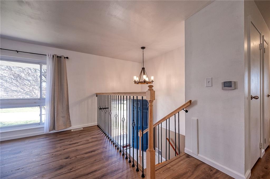 9871 Deerfield Drive Irwin, PA 15642 - Photo 12 of 35 a view of a hallway with wooden floor and staircase