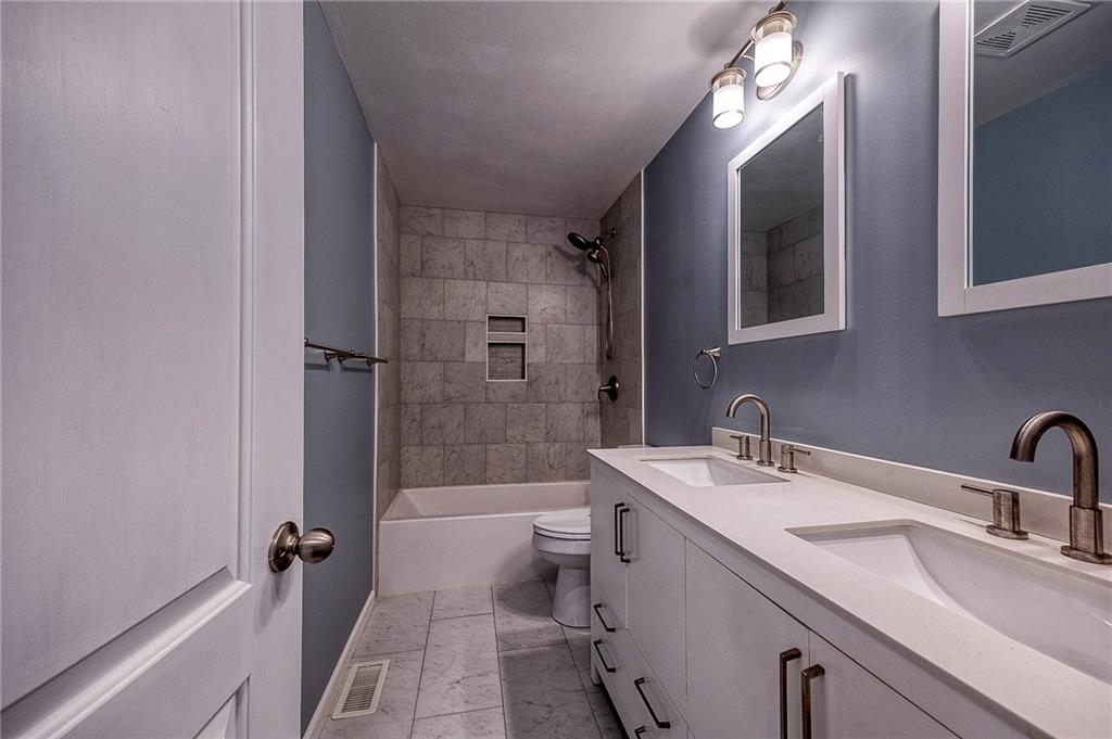 9871 Deerfield Drive Irwin, PA 15642 - Photo 13 of 35 a bathroom with a sink a toilet a mirror and shower