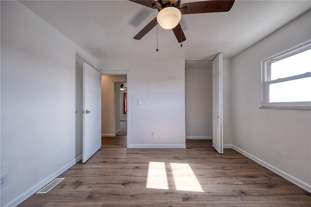 9871 Deerfield Drive Irwin, PA 15642 - Photo 16 of 35 a view of an empty room with wooden floor and window