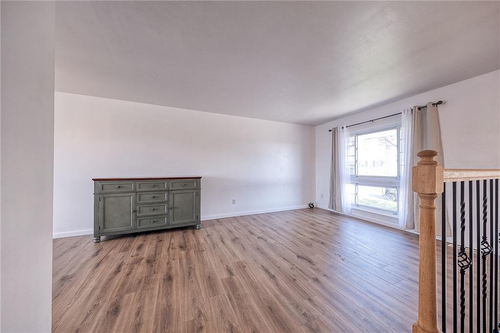9871 Deerfield Drive Irwin, PA 15642 - Photo 7 of 35 an empty room with wooden floor and windows
