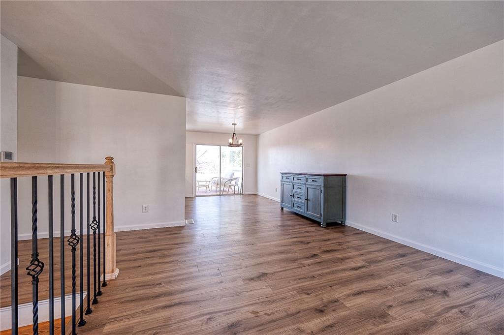 9871 Deerfield Drive Irwin, PA 15642 - Photo 8 of 35 a view of an empty room with wooden floor and a window