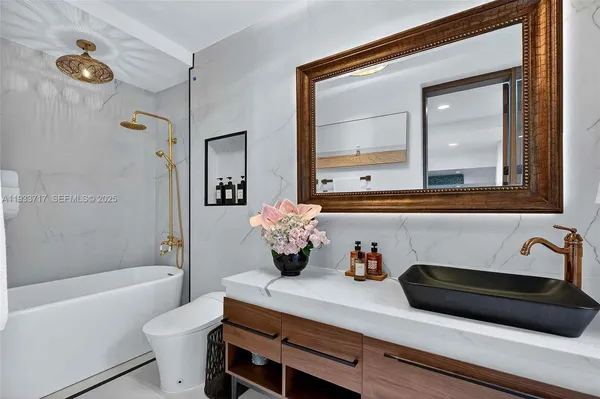a bathroom with a shower sink and mirror