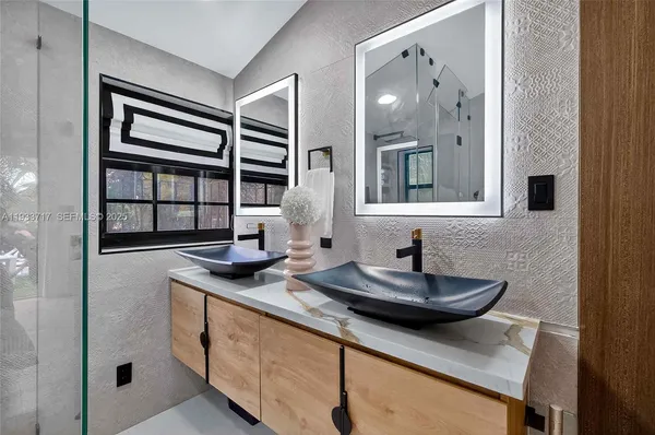a bathroom with a shower and a sink