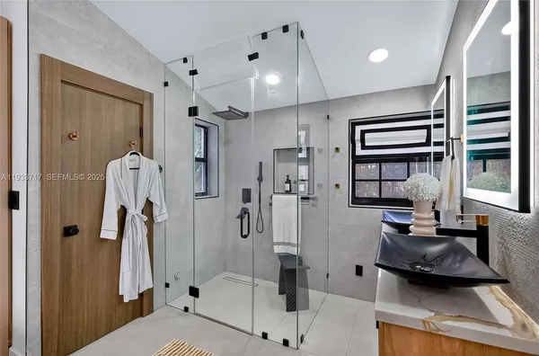 a white bed sitting in a bedroom next to a window