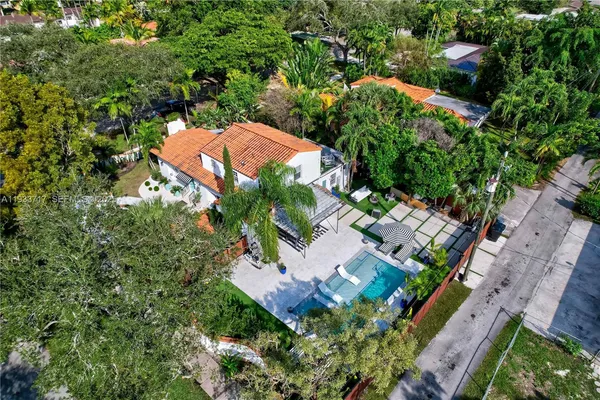 an aerial view of a house with a garden and swimming pool