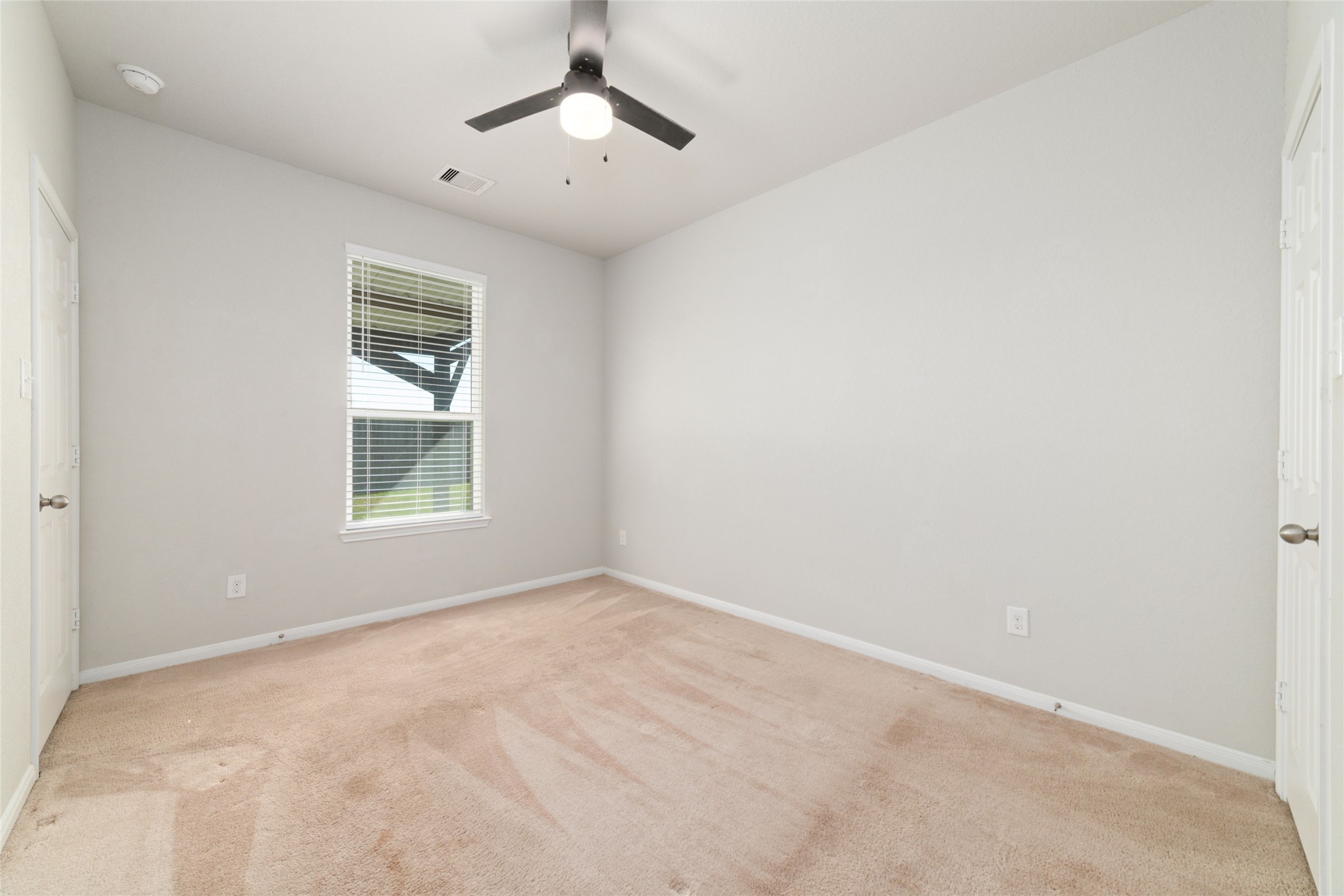 14838 Ruddy Duck Lane Houston, TX 77049 - Photo 14 of 33 Thoughtfully located on the main level, this downstairs bedroom offers excellent flexibility as a primary suite or a private guest retreat, providing convenience, comfort, and adaptable living space.