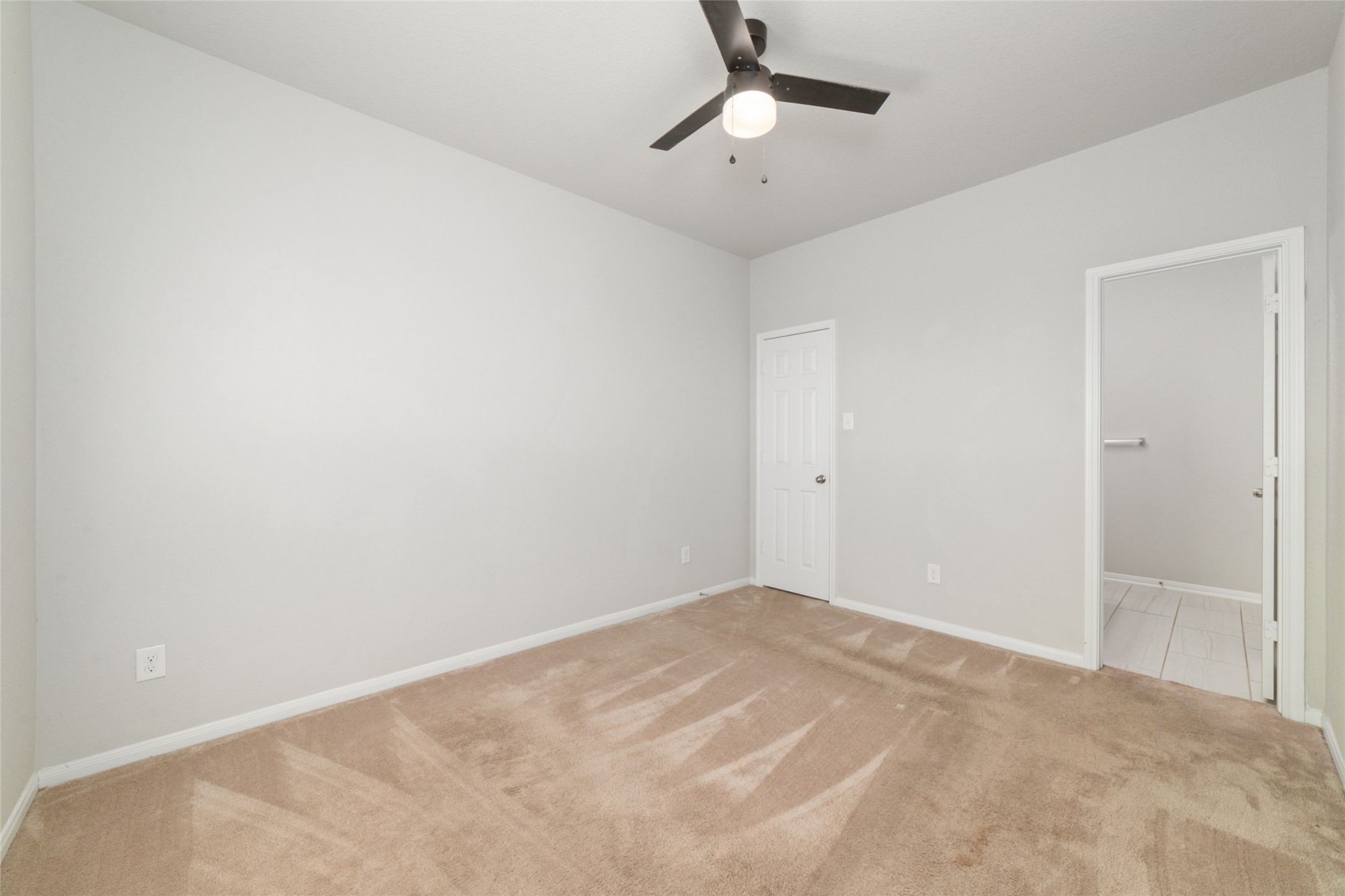 14838 Ruddy Duck Lane Houston, TX 77049 - Photo 15 of 33 Same downstairs bedroom, different view! Located on the main floor, this bedroom offers a versatile layout that can easily function as a guest room, home office, or primary bedroom alternative.