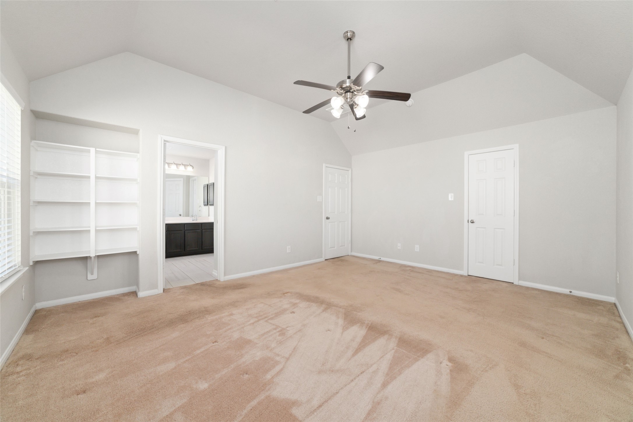 14838 Ruddy Duck Lane Houston, TX 77049 - Photo 20 of 33 Designed for everyday comfort, the primary bedroom includes soft carpet flooring, a ceiling fan, built-in shelving, and direct access to the en-suite bathroom.