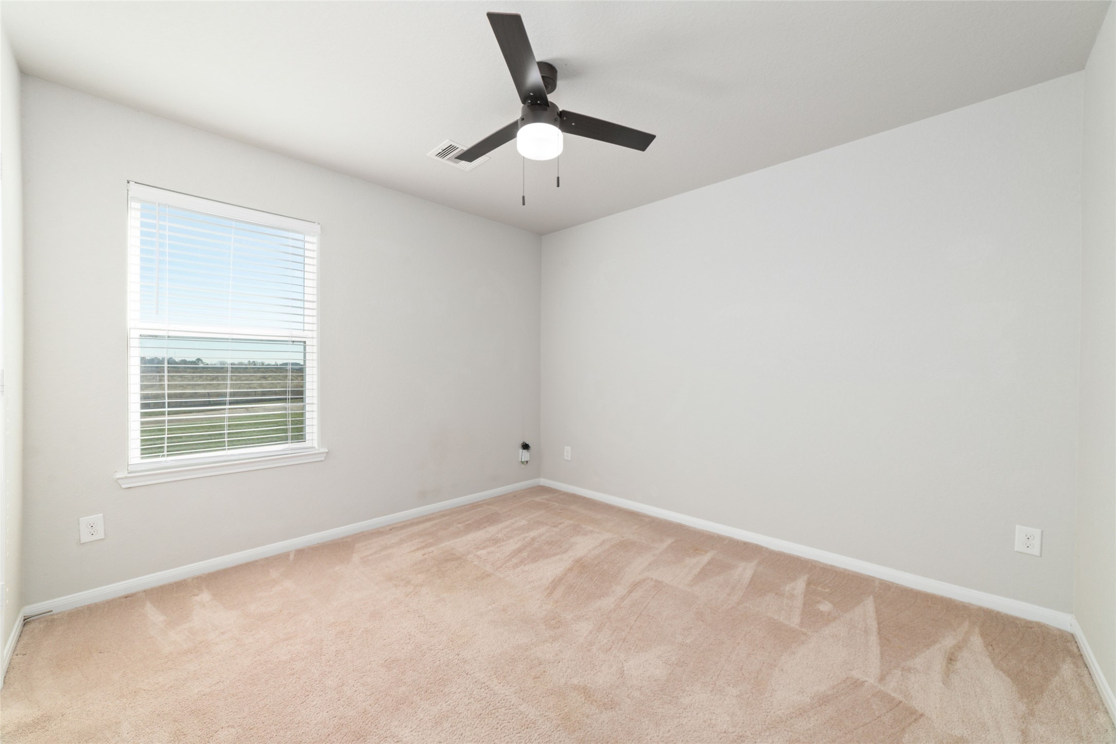 14838 Ruddy Duck Lane Houston, TX 77049 - Photo 26 of 33 With neutral walls, carpeted flooring, and a ceiling fan, this room offers a clean, versatile layout ready for a variety of uses or personal touches. This is the third bedroom upstairs!