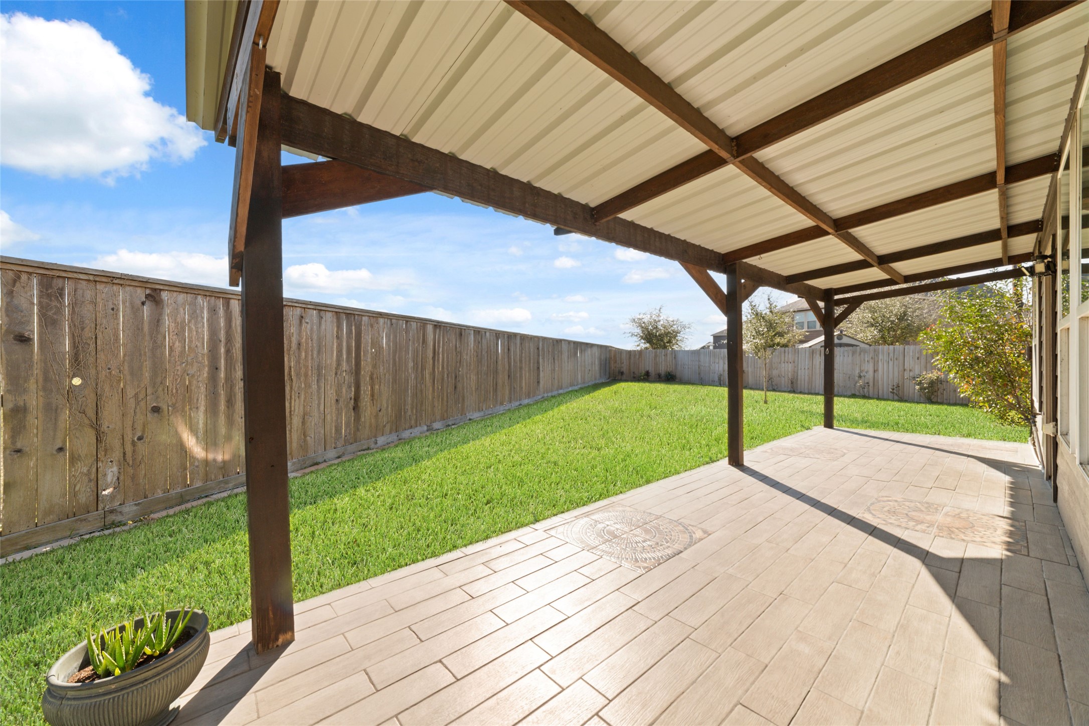 14838 Ruddy Duck Lane Houston, TX 77049 - Photo 28 of 33 The covered patio creates an inviting outdoor extension of the home, offering a comfortable space for dining, relaxing, or enjoying time outside year-round.