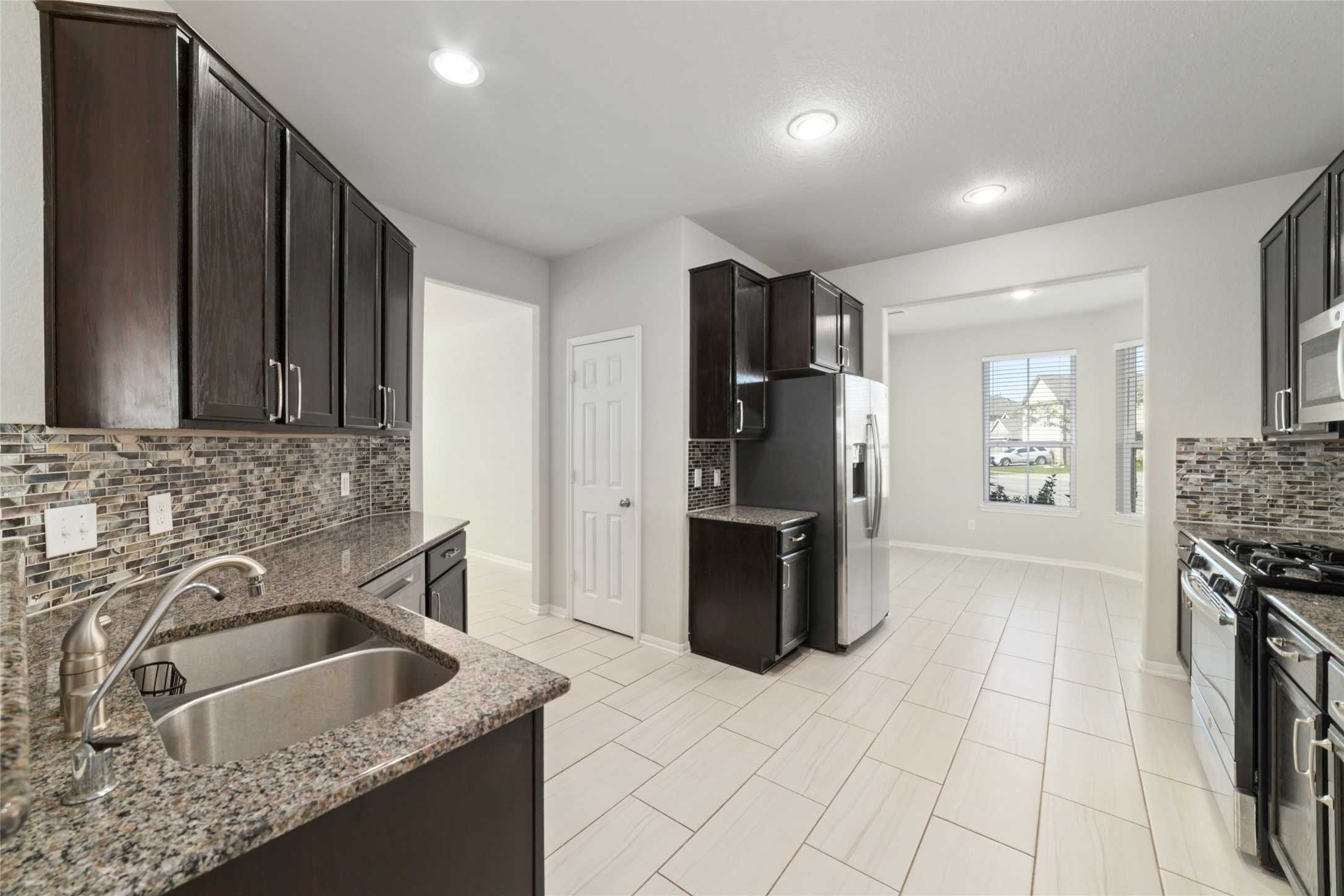 14838 Ruddy Duck Lane Houston, TX 77049 - Photo 8 of 33 Clean lines and modern finishes define this kitchen, offering a sleek, polished look that feels both stylish and practical!