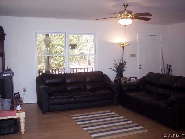 16150 Hopeful Church Road Bumpass, VA 23024 - Photo 2 of 10 a living room with furniture and a chandelier