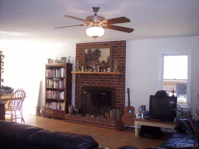 16150 Hopeful Church Road Bumpass, VA 23024 - Photo 3 of 10 a living room with furniture and a fireplace