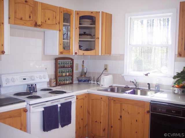 16150 Hopeful Church Road Bumpass, VA 23024 - Photo 5 of 10 a kitchen with a sink stove and cabinets