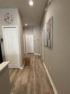 a view of a hallway with wooden floor