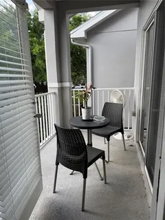 a view of a chairs and table in the balcony