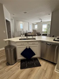 a kitchen with a sink cabinets and stainless steel appliances