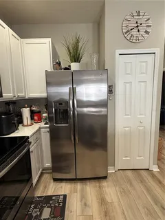 a kitchen with a refrigerator and a stove