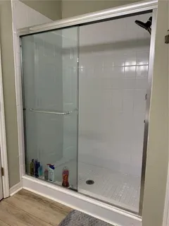 a bathroom with a shower and a mirror