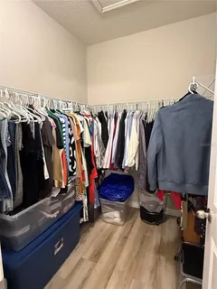 a view of walk in closet with clothes