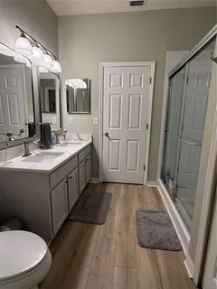 a bathroom with a sink a toilet a mirror and vanity