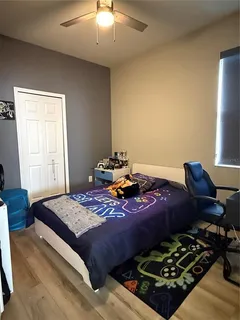 a bed room with a bed and a chair