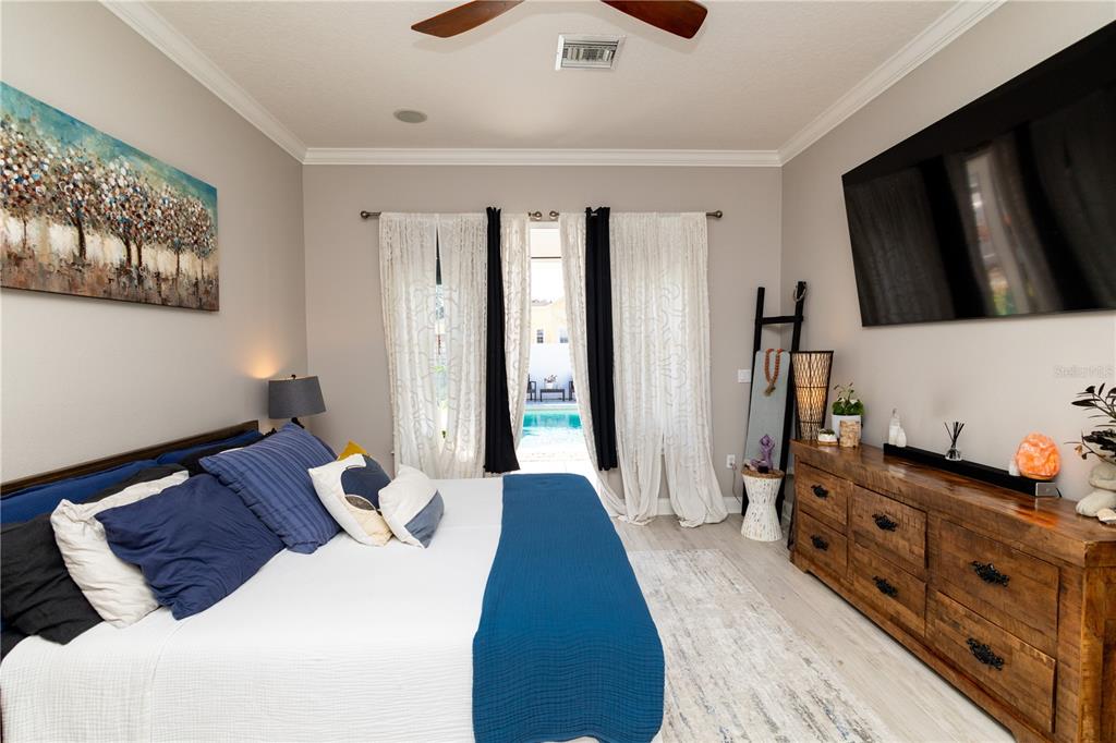 3305 Schoolhouse Road St. Cloud, FL 34773 - Photo 26 of 83 a bedroom with a bed and a flat tv screen on dresser