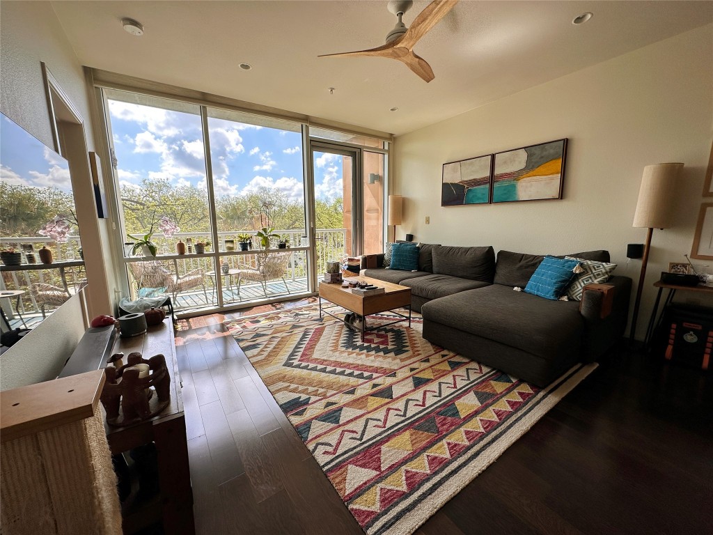 a living room with furniture rug and large windows