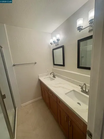 a view of empty room with ceiling fan and window