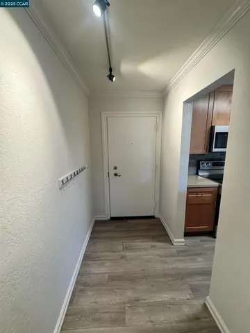 a view of a kitchen with furniture and wooden floor