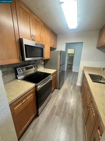 a kitchen with wooden cabinets and a sink