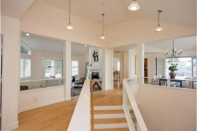 a kitchen with granite countertop a table chairs and wooden floor