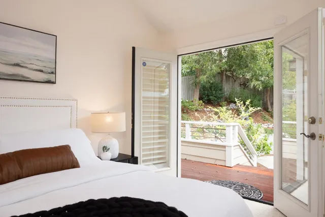 a bedroom with a large window and a bed