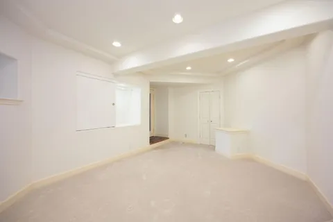 a view of empty room with a kitchen