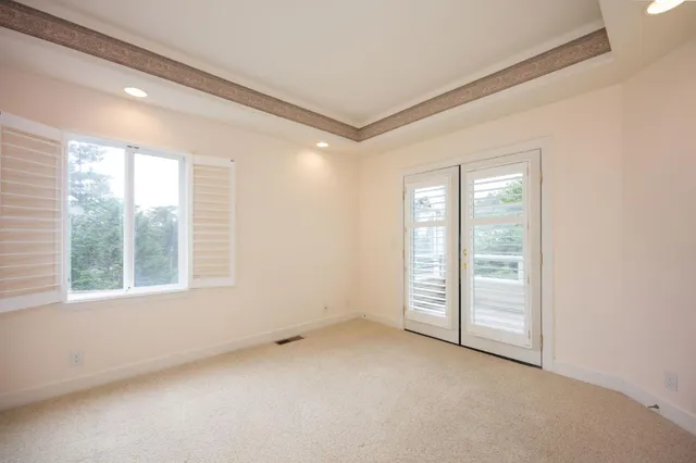 an empty room with windows and closet