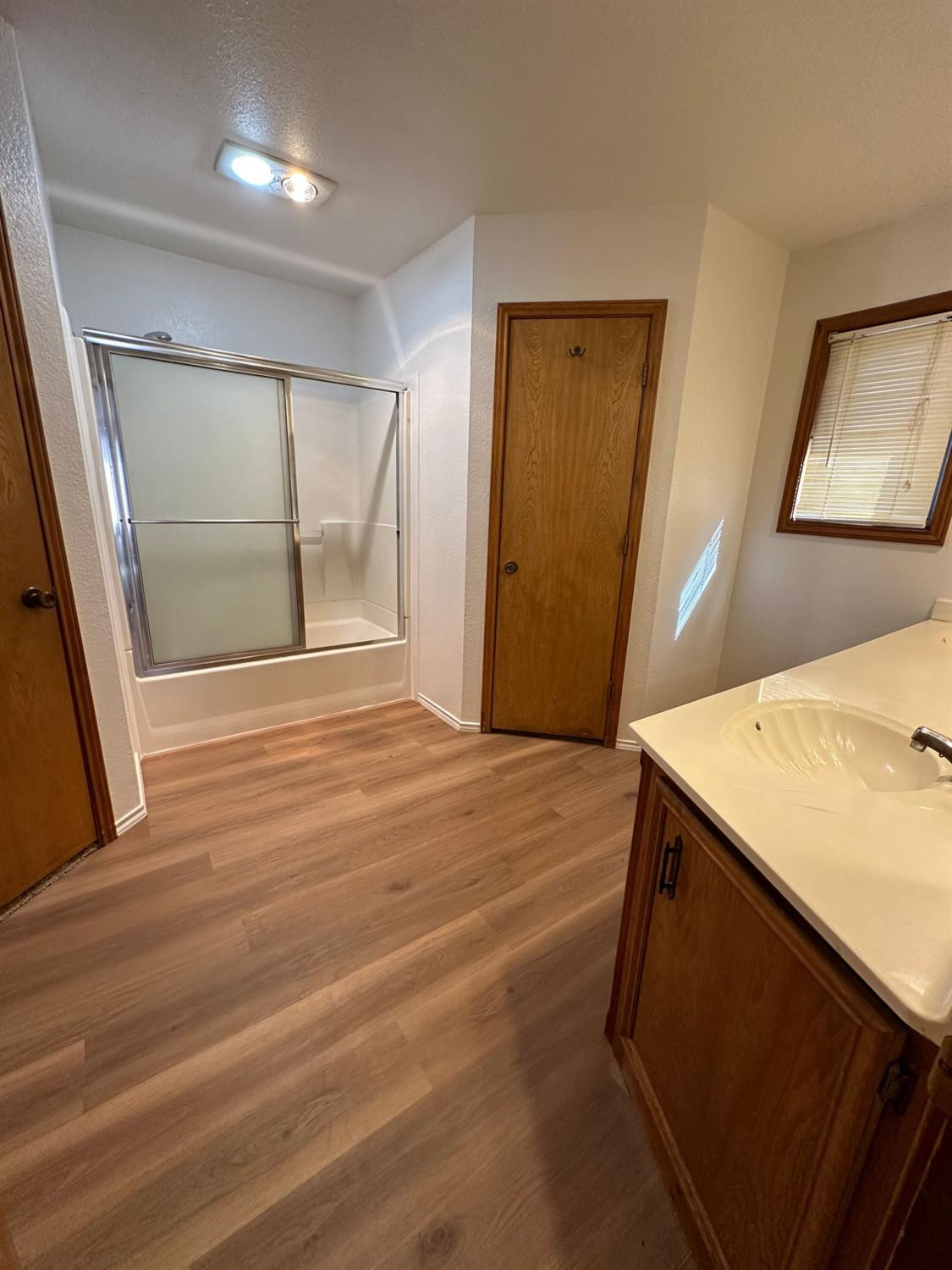 5609 88th Street Lubbock, TX 79424 - Photo 11 of 21 a view of an empty room with wooden floor and a window