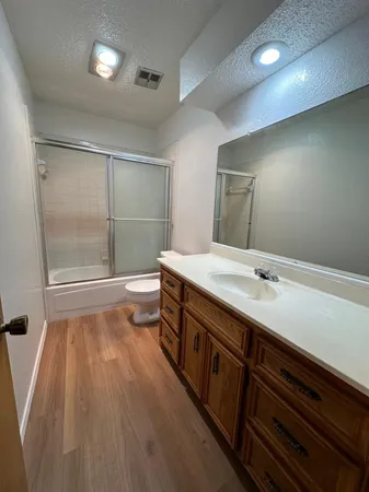a bathroom with a sink a large mirror and shower
