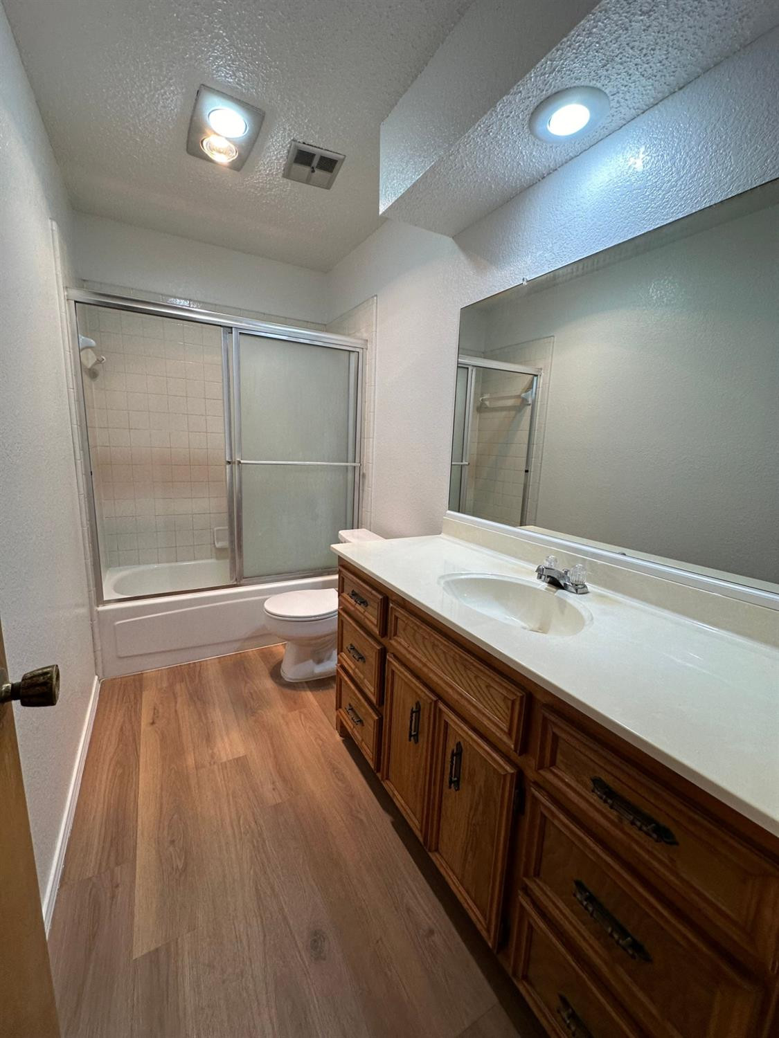 5609 88th Street Lubbock, TX 79424 - Photo 17 of 21 a bathroom with a sink a large mirror and shower