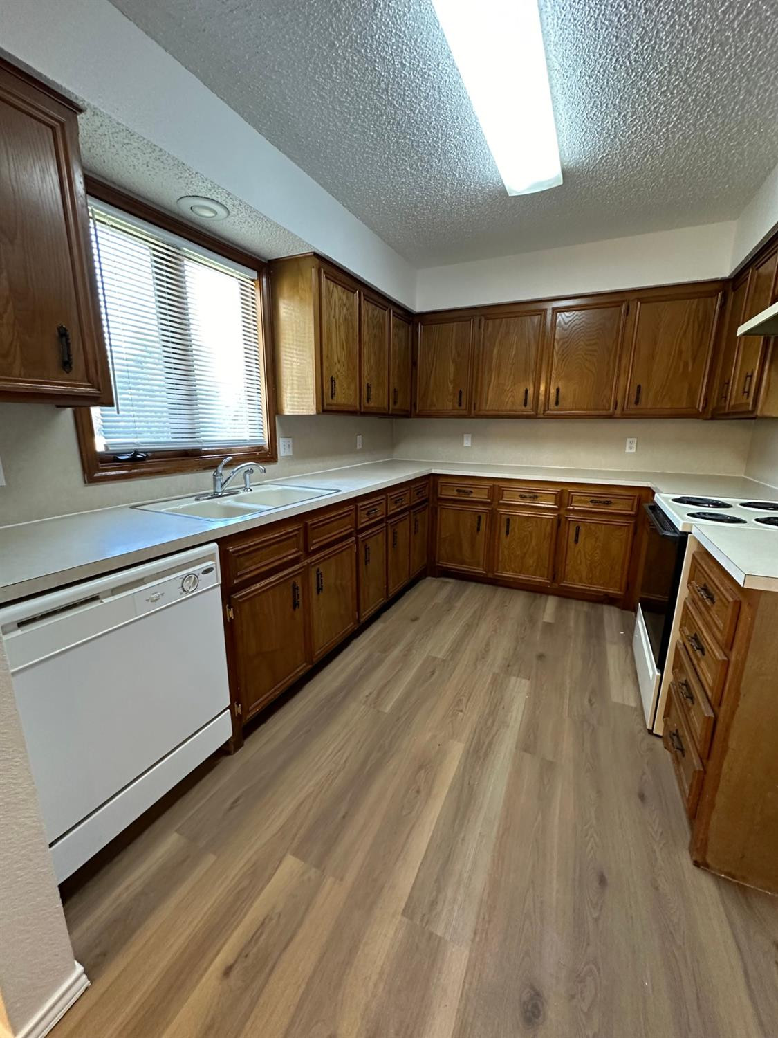 5609 88th Street Lubbock, TX 79424 - Photo 5 of 21 a kitchen with a sink a counter top space and appliances