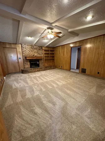 a view of an empty room with a fireplace